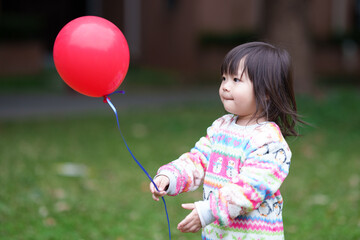 Little girl with a red balloon