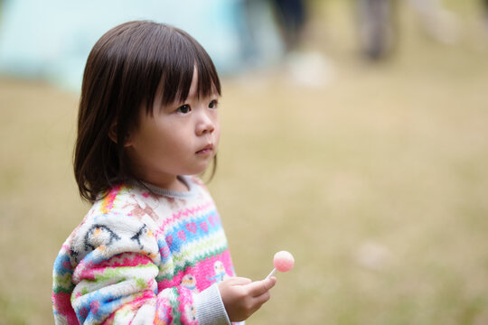 Cute child girl with lollipop