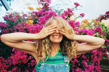 blonde woman with hands over eyes 