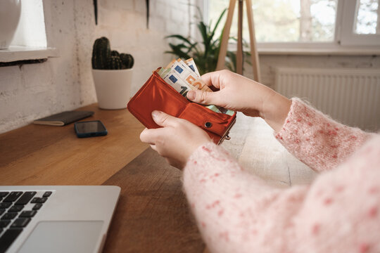Anonymous Woman Putting Money In The Wallet 