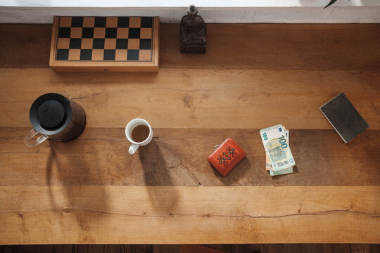 Overhead View Of A Wallet and Euro Bills On The Desk
