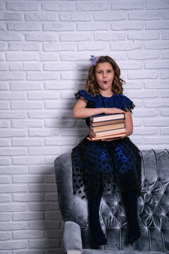 Portrait of a little girl reading a book. Reading literature outside the classroom.