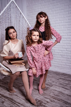 The sisters are reading a book at home. Children's literature.