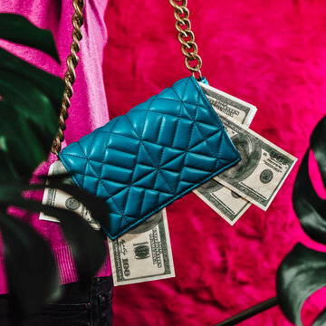 fake dollar bills in a blue purse