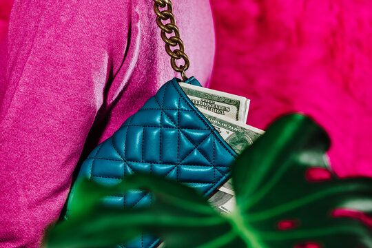 carrying a purse with some fake dollar bills