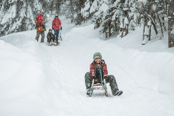 boy riding his sled