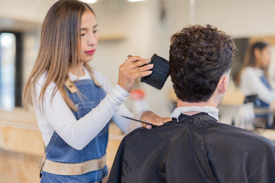 Barber brushing hairs