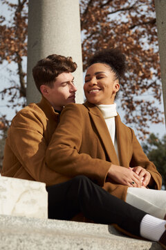 Couple back hugging at a classic column building