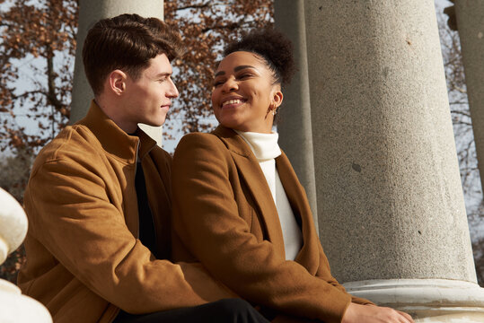 Couple back hugging at a classic column building