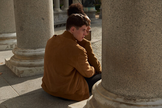 Couple back hugging at a classic column building
