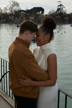 Couple hugging next to a lake park