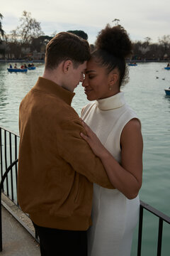 Couple hugging next to a lake park