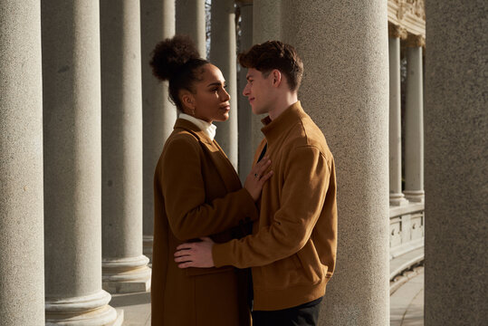 Couple looking at each other at a column corridor