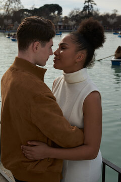 Couple hugging next to a lake park