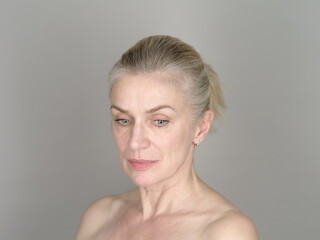 Thoughtful adult model on gray