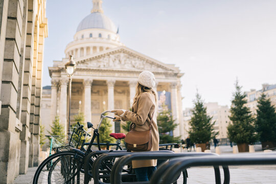 Stylish lady admiring city architecture during trip