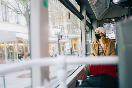 A woman with a mask on a bus