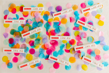 Covid 19 rapid tests on colorful confetti