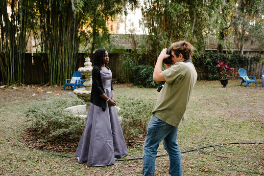 Teen photographer and African American girl