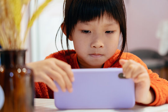 Child girl playing with mobile phone