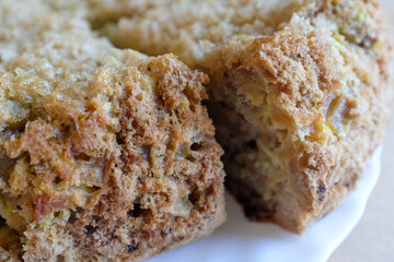 A pieces of apple pie on a white plate, close-up. Homemade bakery. Charlotte pie for publication, design, poster, calendar, post, screensaver, wallpaper, postcard, card, banner, cover, website