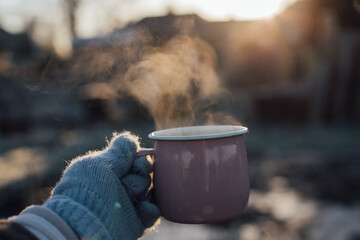 Hand Holding A Steaming Mug