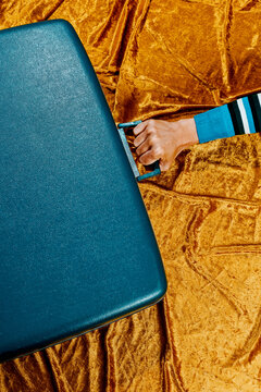 man grabs the handle of a retro blue suitcase