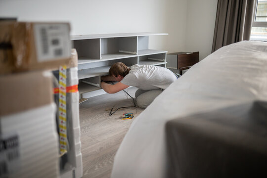 Flat Renovation. Man Disassembling Furniture