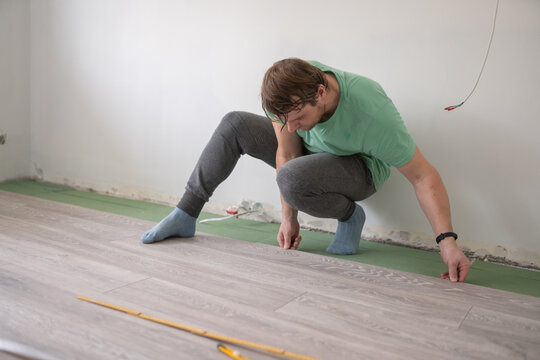 Handyman Laying Laminate Flooring