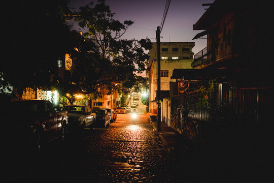 A motorcycle down a street at dusk.