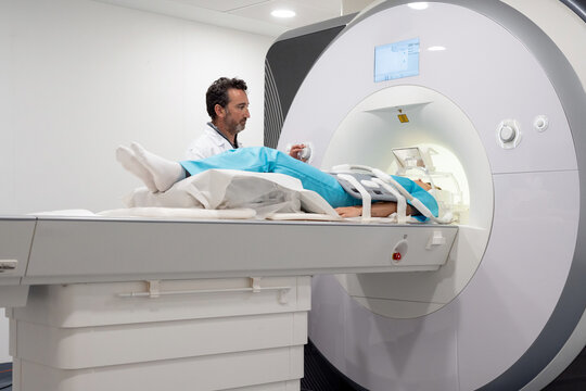 Doctor doing MRI procedure in clinic