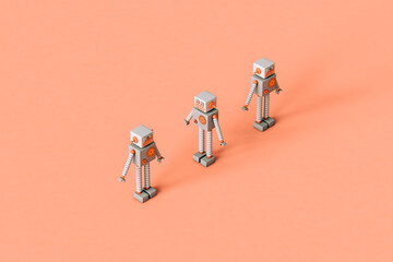 three tiny Toy robots on a pink background