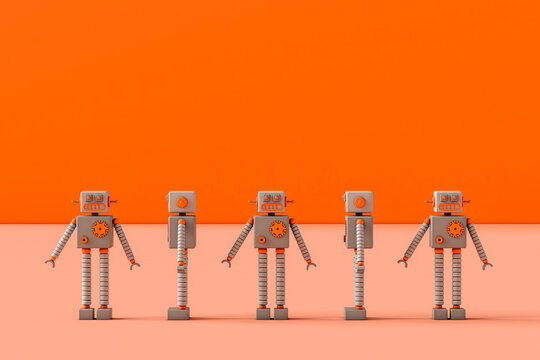 frontal view of Toy robots on a pink background