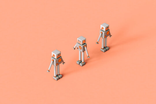 three tiny Toy robots on a pink background