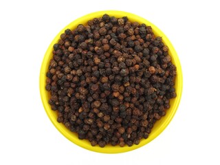 Black peppers in a bowl top view 