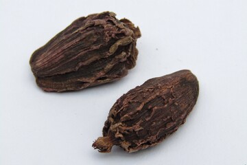 Black cardamom on white background 