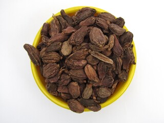 Black cardamom in a bowl top view 