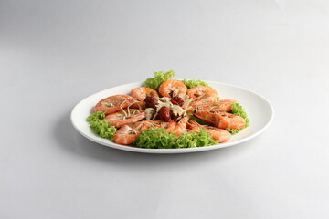 steamed fresh poached tiger prawn with vegetable lettuce on white plate background chinese banquet halal seafood menu