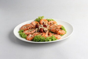 steamed fresh poached tiger prawn with vegetable lettuce on white plate background chinese banquet halal seafood menu