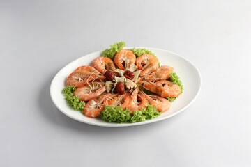 steamed fresh poached tiger prawn with vegetable lettuce on white plate background chinese banquet halal seafood menu