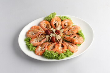 steamed fresh poached tiger prawn with vegetable lettuce on white plate background chinese banquet halal seafood menu