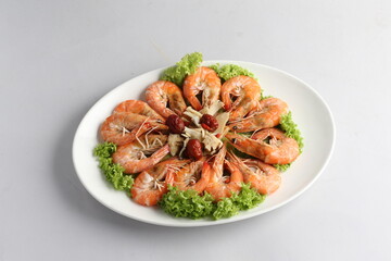 steamed fresh poached tiger prawn with vegetable lettuce on white plate background chinese banquet halal seafood menu