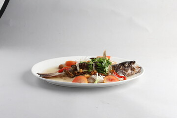 teo chew steamed whole fresh red grouper fish in salted vegetable tomato sauce chinese banquet halal seafood menu on white background