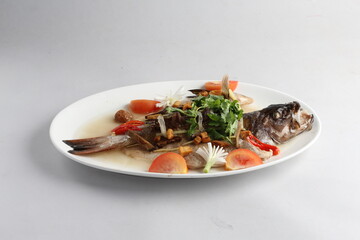 teo chew steamed whole fresh red grouper fish in salted vegetable tomato sauce chinese banquet halal seafood menu on white background