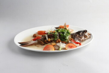 teo chew steamed whole fresh red grouper fish in salted vegetable tomato sauce chinese banquet halal seafood menu on white background