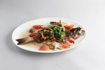 teo chew steamed whole fresh red grouper fish in salted vegetable tomato sauce chinese banquet halal seafood menu on white background