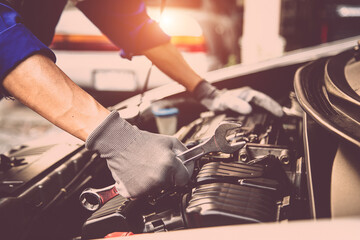 Car care maintenance and servicing, Close-up hand technician auto mechanic using the wrench to repairing change spare part car engine problem and insurance service support.