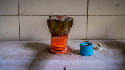 Closeup of an old pastic water tap in a derelict house
