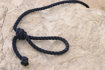 A black rope on a rock