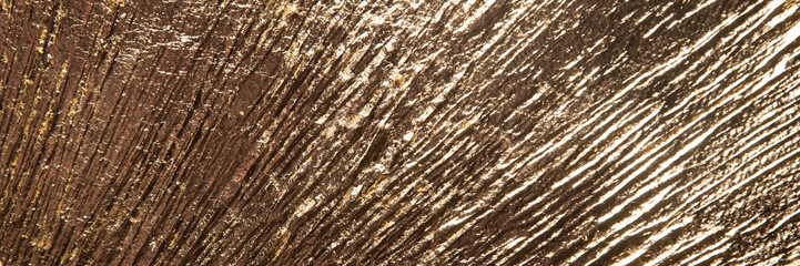 area of radially crumpled gold patina, flare effect, short focus